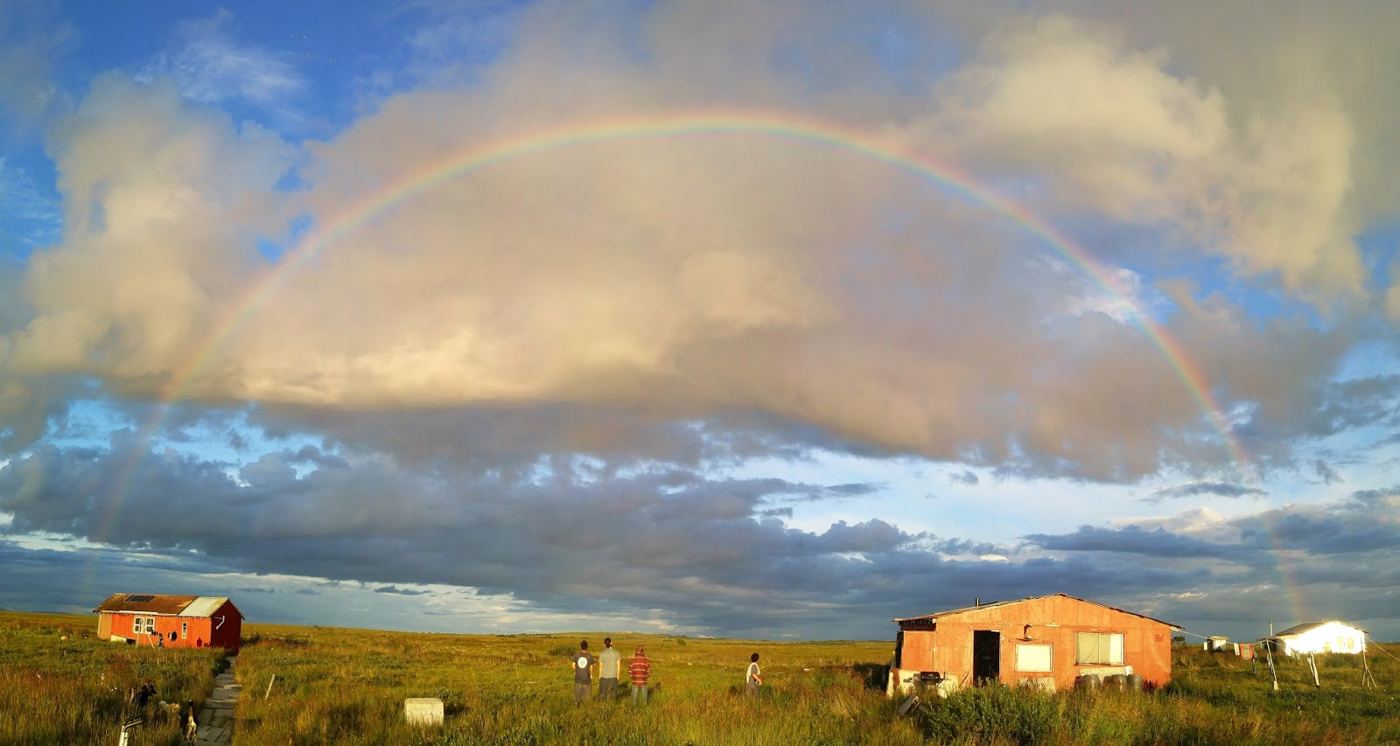 Rainbow over the family's fish camp cabins on the tundra